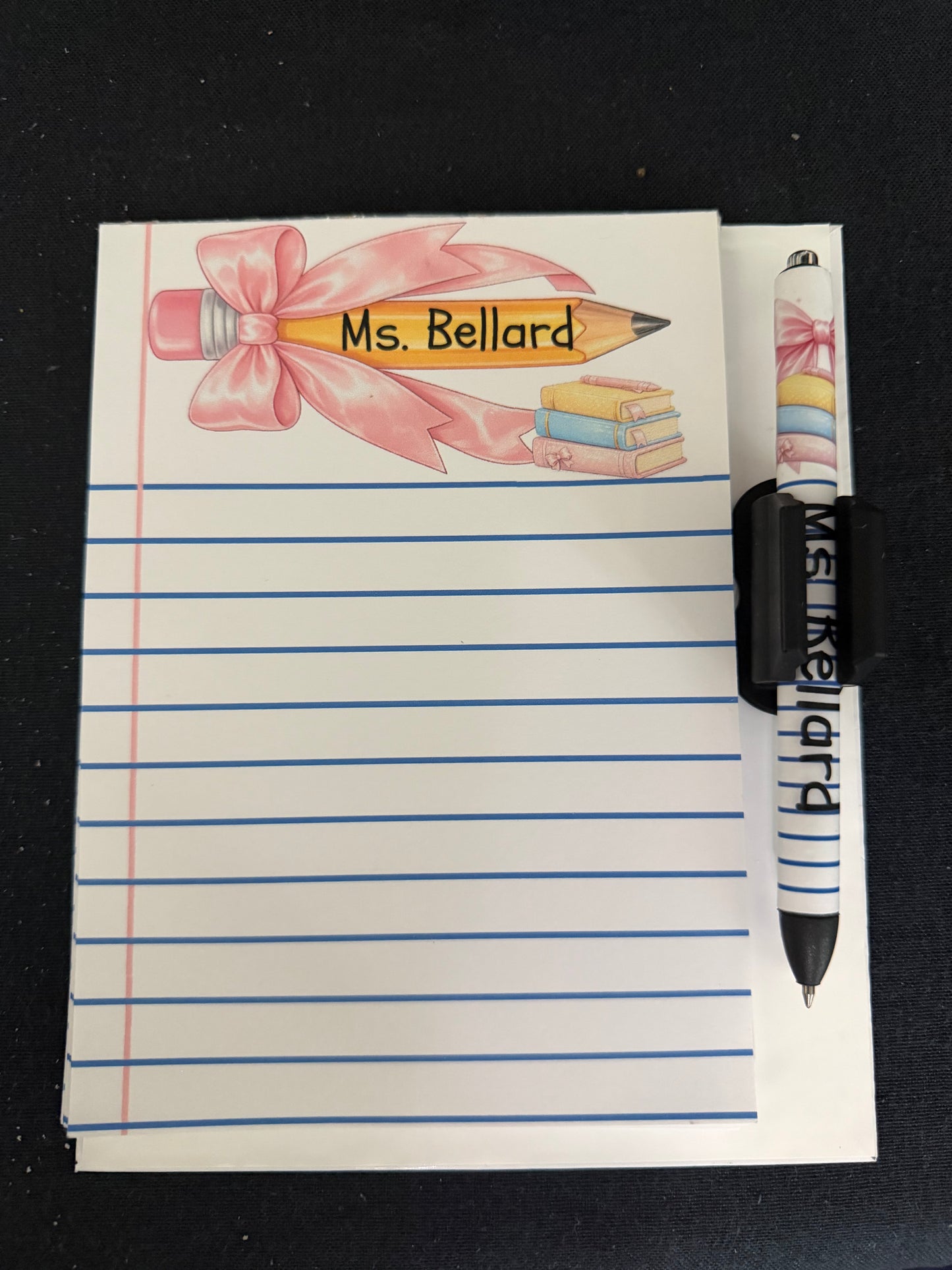 Printable teacher notepad cover featuring a personalized classroom design with black and gold accents and lined note pages.
